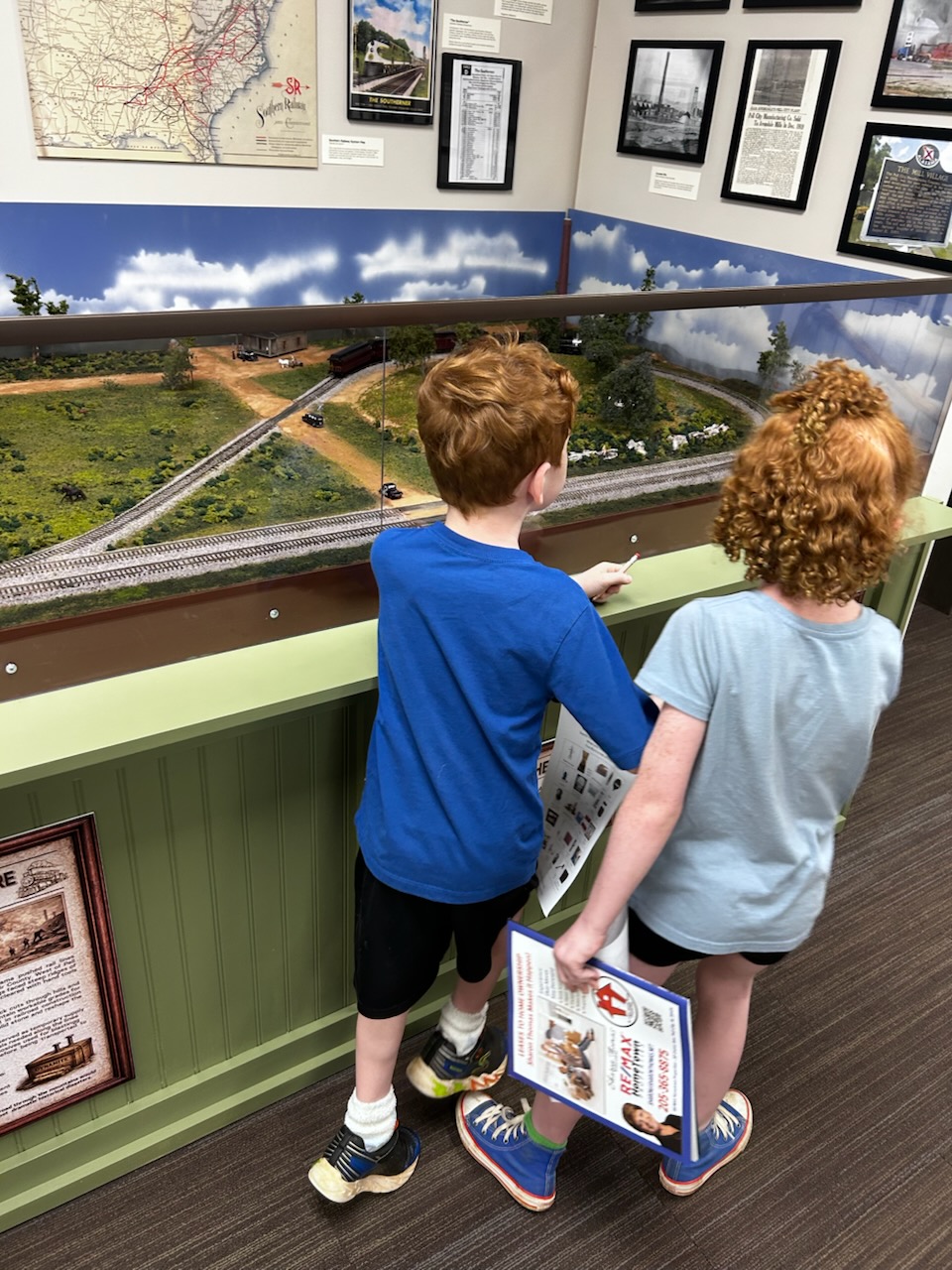 Support Brings History To Life Children looking at the model railway